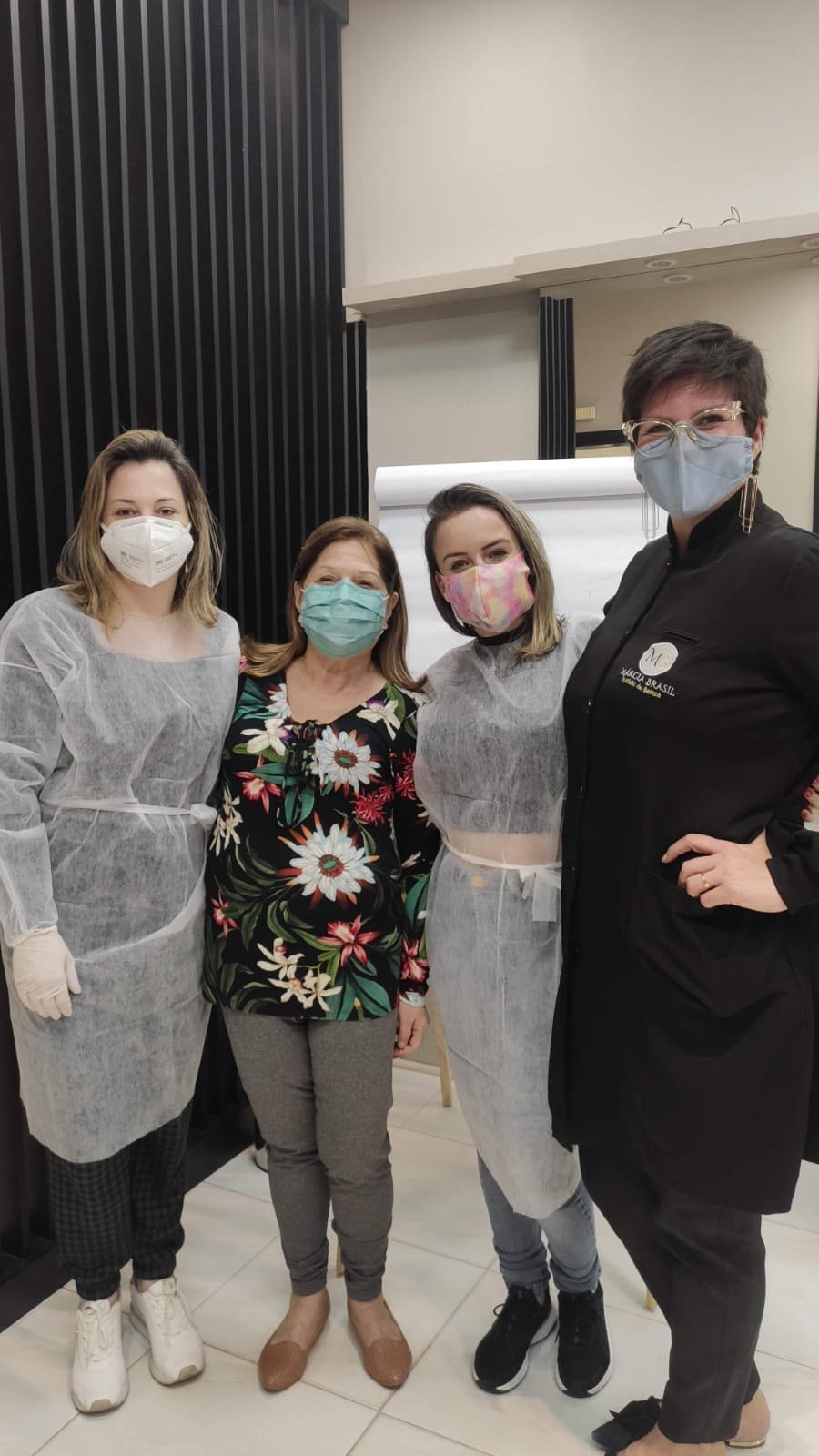 Márcia Brasil com alunas de máscara em aula prática, em 2021